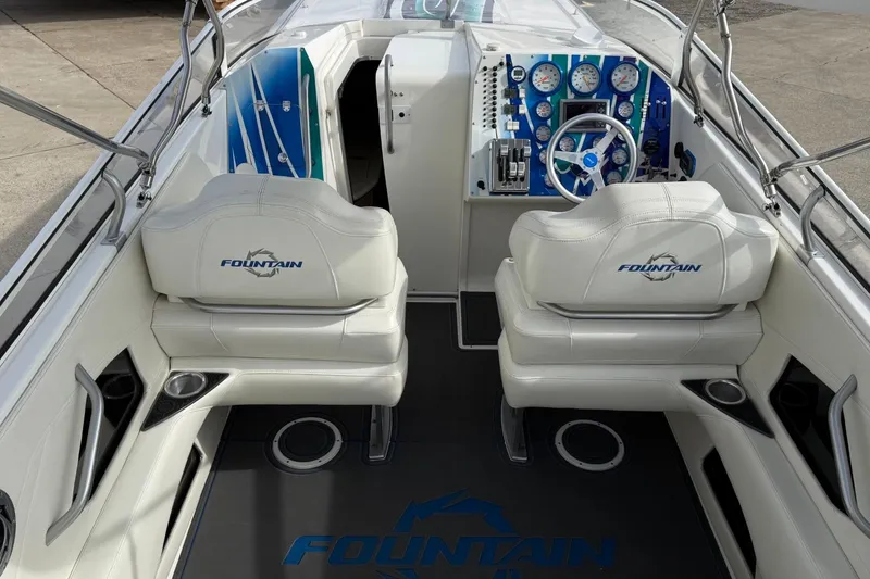 Slide: The Image of 2010 Fountain 42 Lightning boat interior with white seats and blue dashboard. - 7