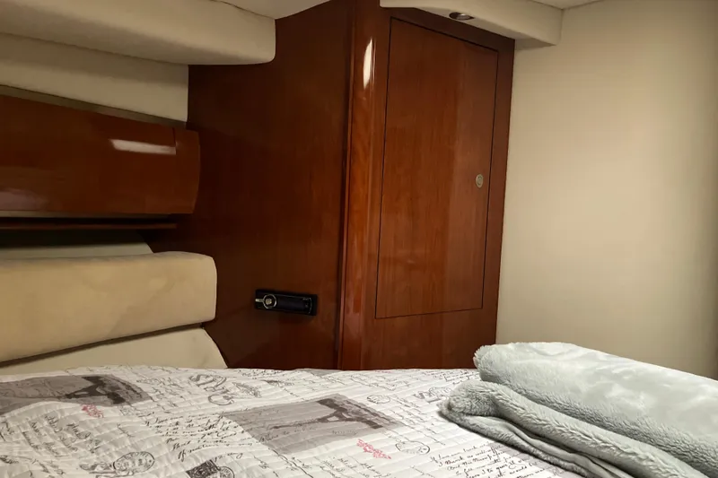 Slide: The Image of Luxurious cabin interior of 2004 Sea Ray 500 Sundancer yacht with wooden accents. - 15