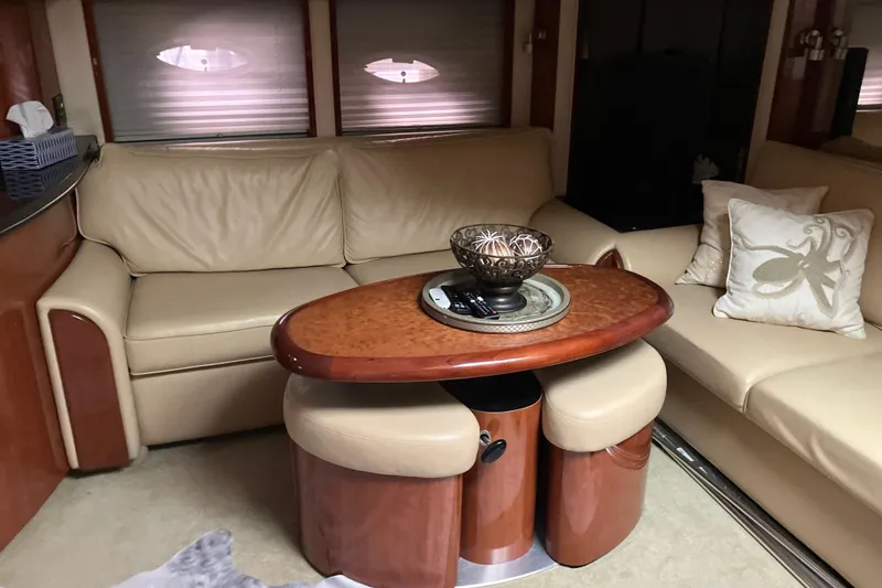 Slide: The Image of Luxurious interior of 2004 Sea Ray 500 Sundancer with leather seating and elegant wooden table. - 16