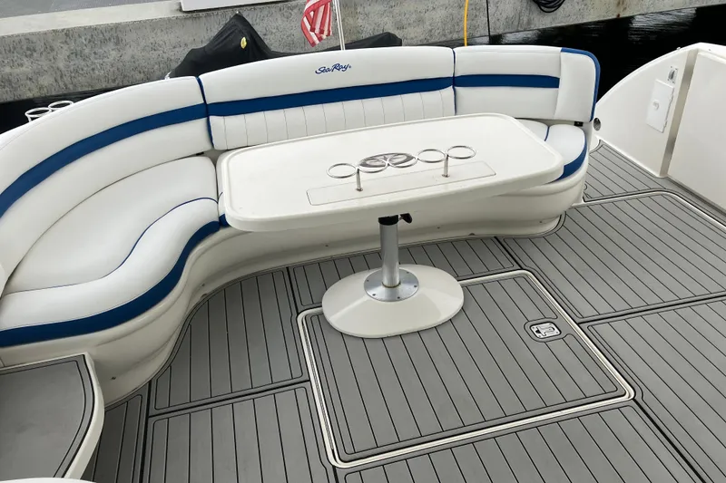 Slide: The Image of 2004 Sea Ray 500 Sundancer boat deck with curved seating and table. - 8