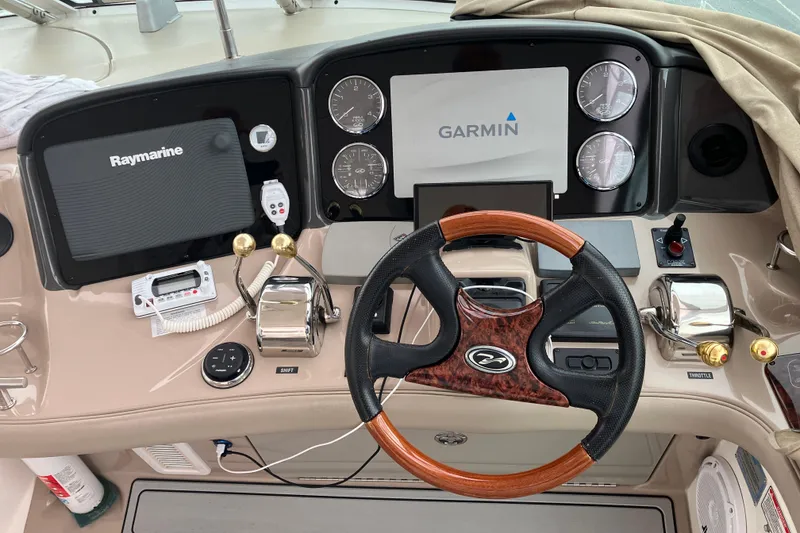 Slide: The Image of Cockpit of 2004 Sea Ray 500 Sundancer with Garmin and Raymarine navigation systems. - 9