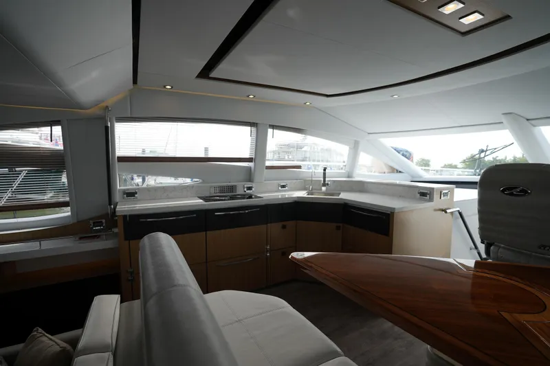 Slide: The Image of Luxurious interior of 2018 Sea Ray L590 Fly yacht with modern kitchen and seating area. - 16