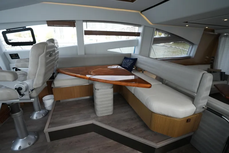 Slide: The Image of Luxurious interior of 2018 Sea Ray L590 Fly yacht with plush seating and wooden table. - 18