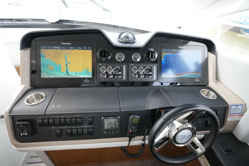 Slide: The Image of 2018 Sea Ray L590 Fly helm with advanced navigation displays and controls. - 25