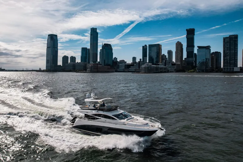 Slide: The Image of 2018 Sea Ray L590 Fly yacht cruising near city skyline on a sunny day. - 3