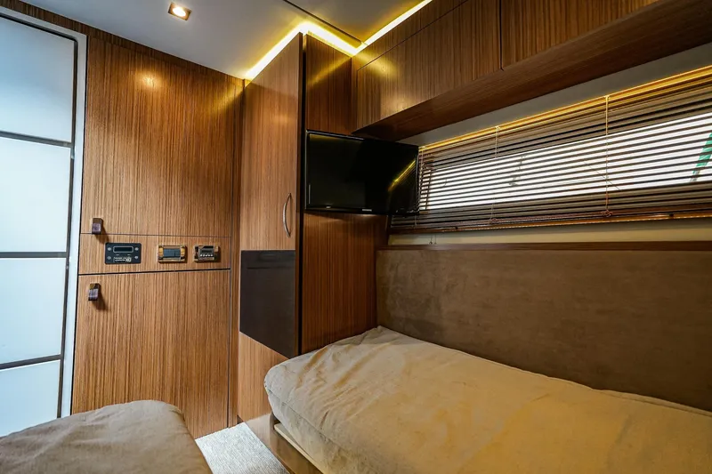 Slide: The Image of Luxurious 2018 Sea Ray L590 Fly cabin interior with wood paneling and modern amenities. - 30