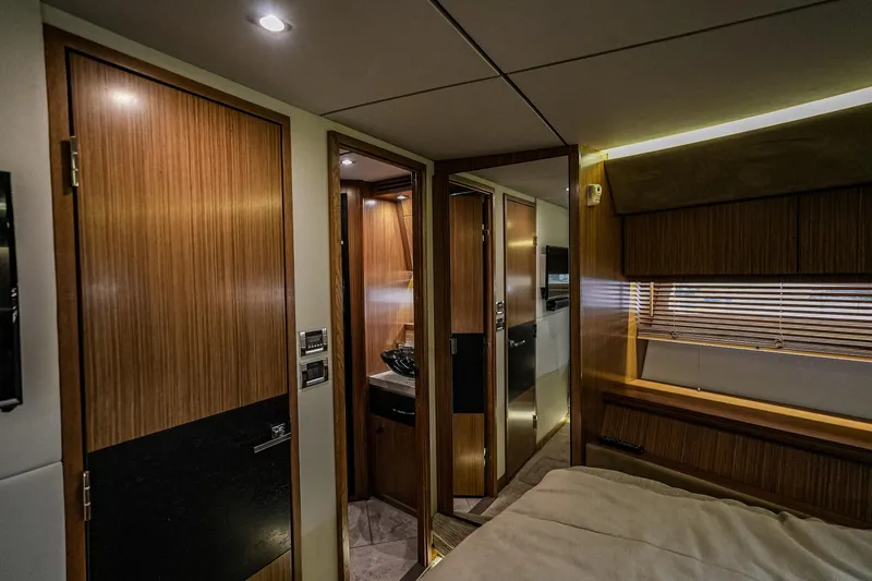 Slide: The Image of Luxurious interior of 2018 Sea Ray L590 Fly yacht cabin with wood finishes. - 31