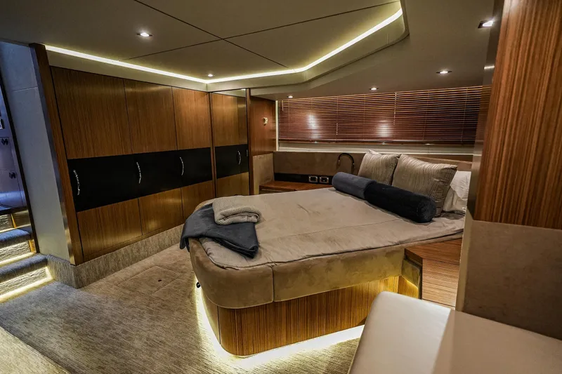 Slide: The Image of Luxurious 2018 Sea Ray L590 Fly yacht bedroom with modern wood finishes and ambient lighting. - 34