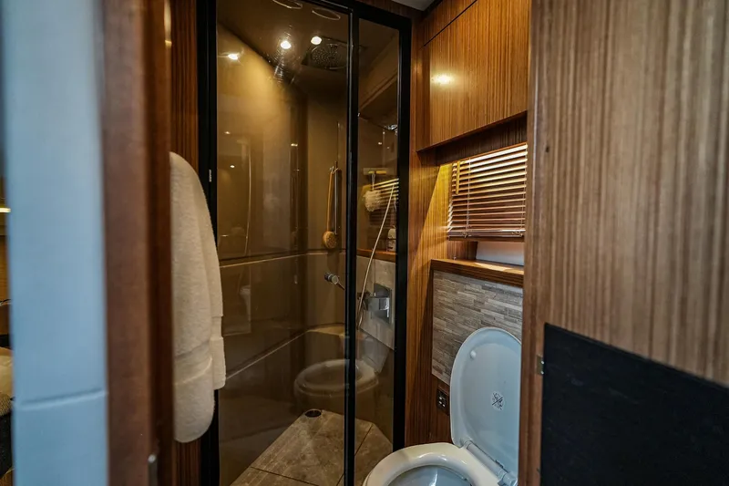 Slide: The Image of Luxurious bathroom interior of 2018 Sea Ray L590 Fly yacht with shower and toilet. - 41