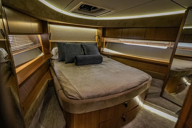 Slide: The Image of Luxurious cabin interior of 2018 Sea Ray L590 Fly yacht with cozy bed and elegant wood finish. - 42