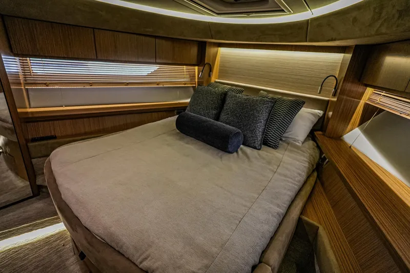 Slide: The Image of Luxurious 2018 Sea Ray L590 Fly yacht bedroom with elegant wood finishes and cozy bedding. - 44