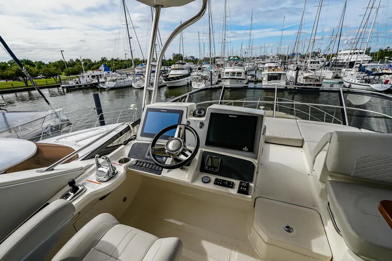 Slide: The Image of Flybridge of 2018 Sea Ray L590 Fly yacht with marina view. - 51