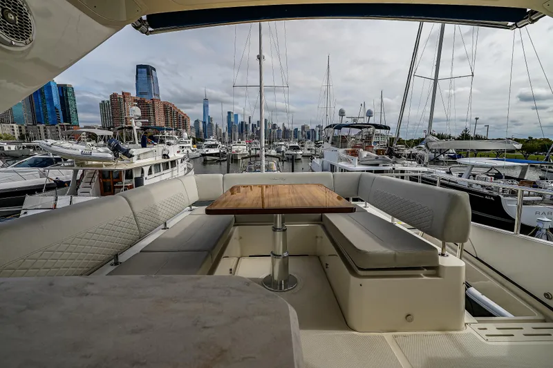 Slide: The Image of Luxurious 2018 Sea Ray L590 Fly yacht interior with city skyline and marina view. - 53