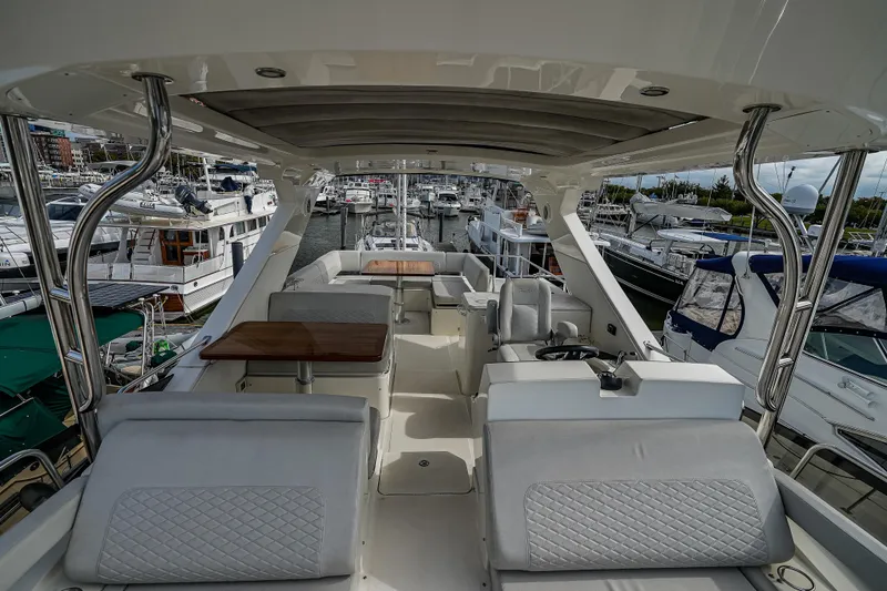 Slide: The Image of Luxurious 2018 Sea Ray L590 Fly yacht interior with elegant seating and helm station. - 56