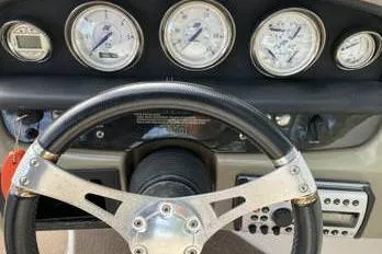 Slide: The Image of Dashboard of 2007 Four Winns 204 Funship boat with gauges and steering wheel. - 11