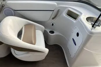 Slide: The Image of 2007 Four Winns 204 Funship boat interior with white seating and control panel. - 12