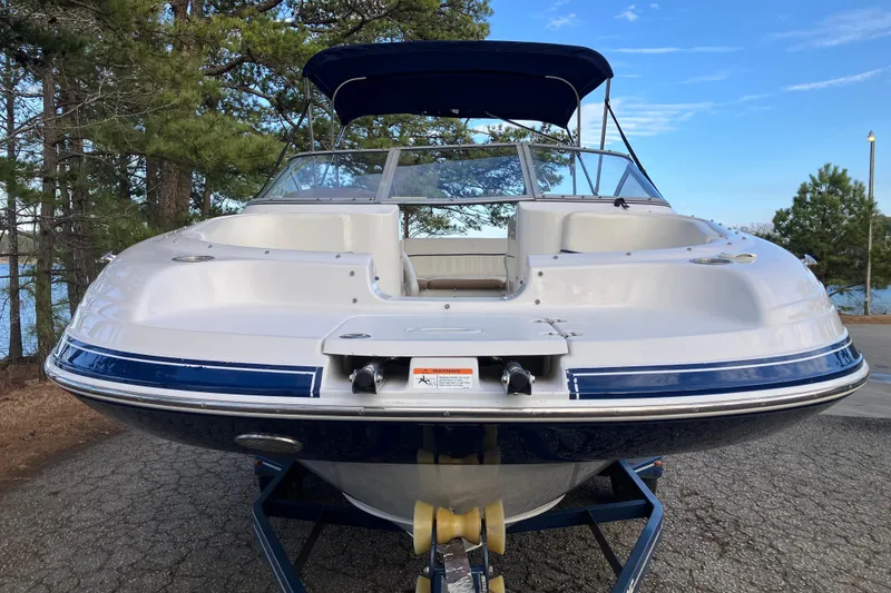 Slide: The Image of 2007 Four Winns 204 Funship boat on trailer, parked near trees and lake. - 4