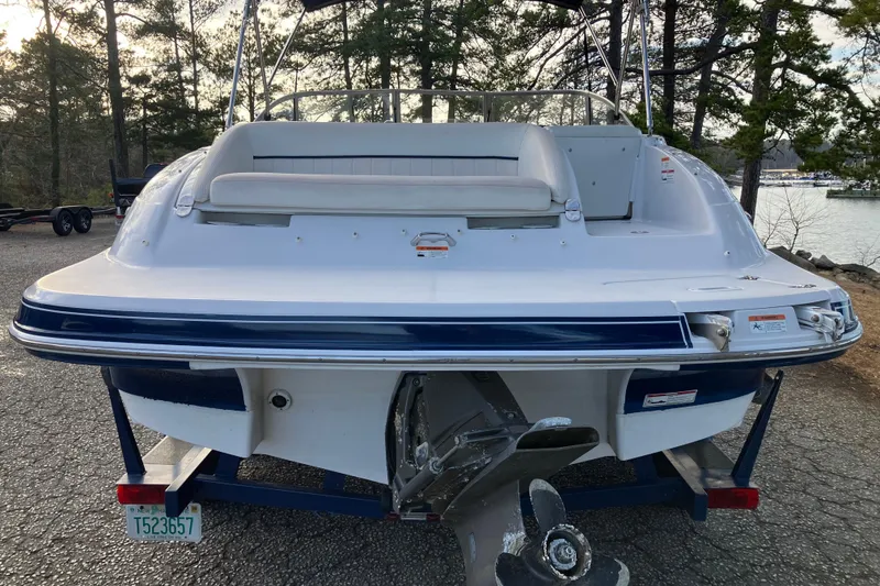 Slide: The Image of 2007 Four Winns 204 Funship boat rear view, parked near a lake with trees. - 5