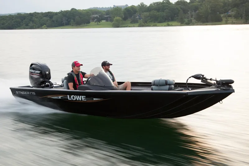 Slide: The Image of Manufacturer Provided Image: 2016 Lowe Stinger 175 boat cruising on a lake with two passengers. - 13