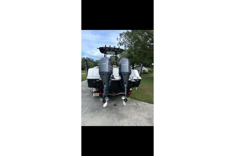 Slide: The Image of 2017 Sportsman Open 252 Center Console boat with dual outboard motors. - 2