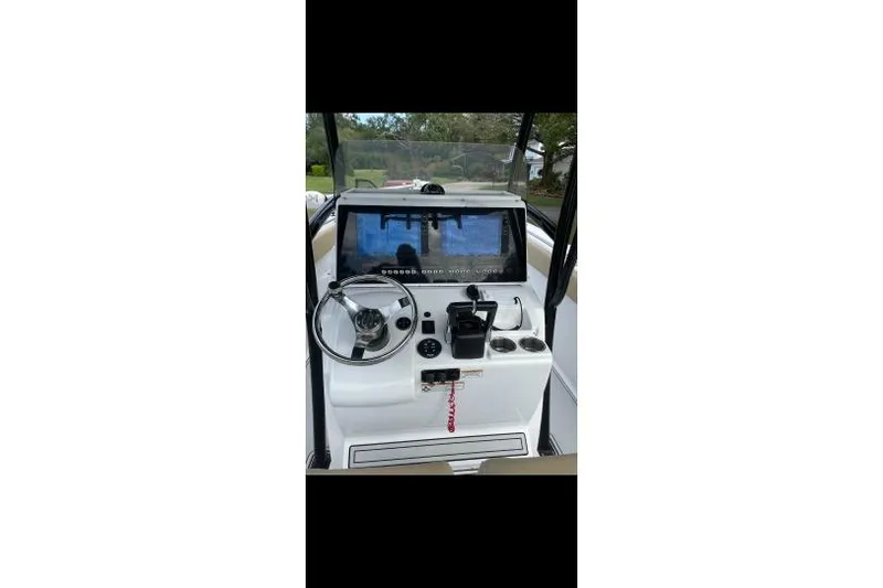 Slide: The Image of 2017 Sportsman Open 252 Center Console boat dashboard with steering wheel and controls. - 4