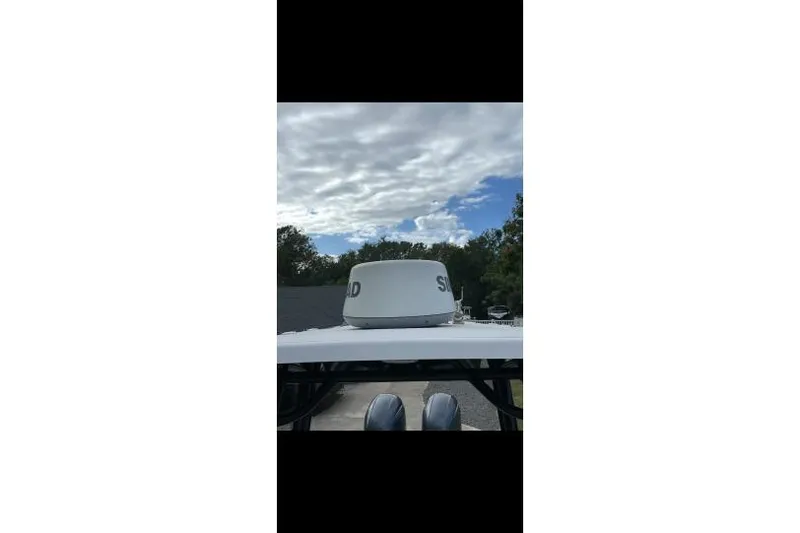 Slide: The Image of 2017 Sportsman Open 252 Center Console with radar dome under cloudy sky. - 5