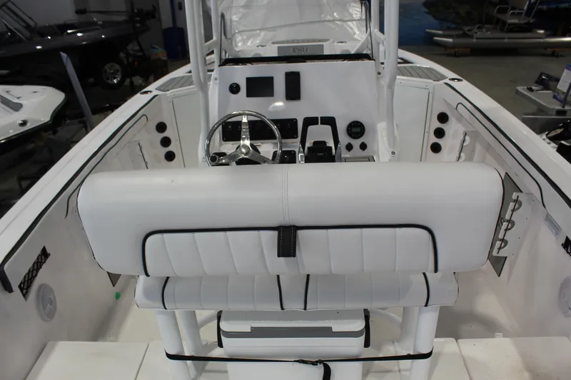 Slide: The Image of 2025 Yamaha Boats 222 FSH Sport interior with white seating and control panel. - 2