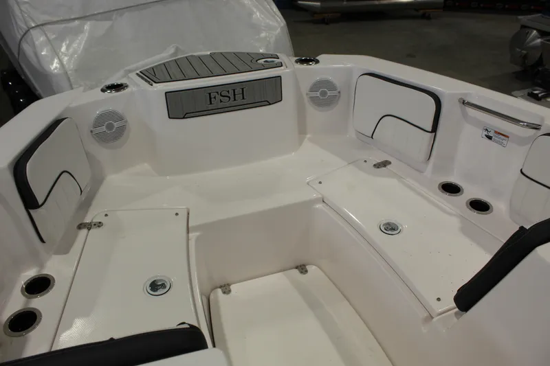 Slide: The Image of 2025 Yamaha Boats 222 FSH Sport interior seating area with cup holders and speakers. - 9