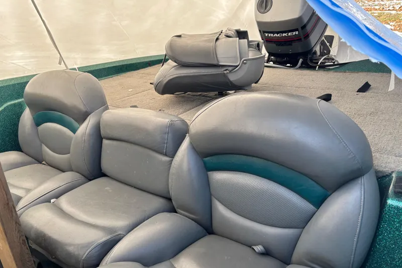Slide: The Image of 1997 Nitro 700 LX DC boat interior with gray leather seats and Tracker motor. - 3