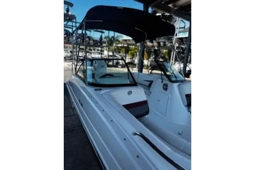 Slide: The Image of 2023 Hurricane SunDeck Sport 188 OB boat with canopy in marina setting. - 2