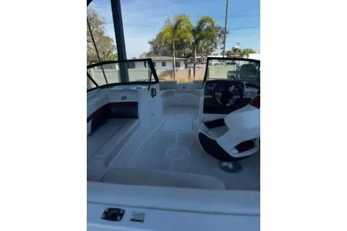 Slide: The Image of 2023 Hurricane SunDeck Sport 188 OB boat interior with seating and steering wheel. - 5