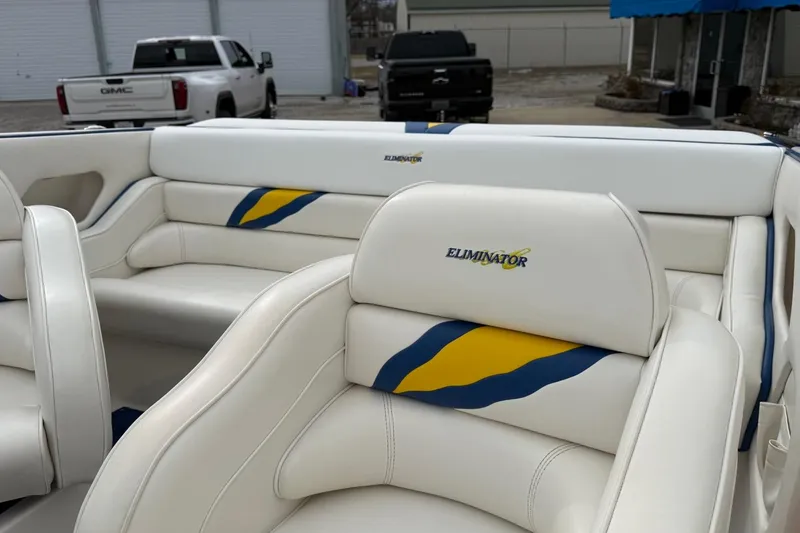 Slide: The Image of 2004 Eliminator 280 Eagle XP boat interior with white, blue, and yellow upholstery. - 10
