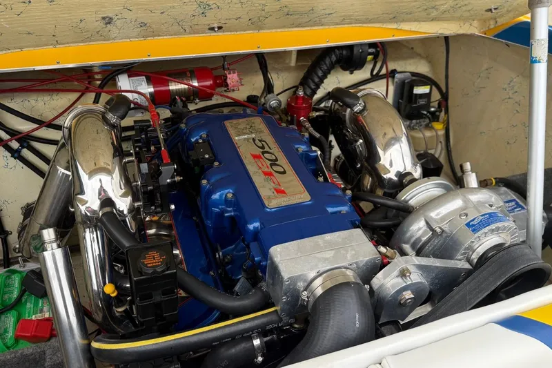 Slide: The Image of Engine compartment of a 2004 Eliminator 280 Eagle XP boat, featuring a powerful Mercury engine. - 11