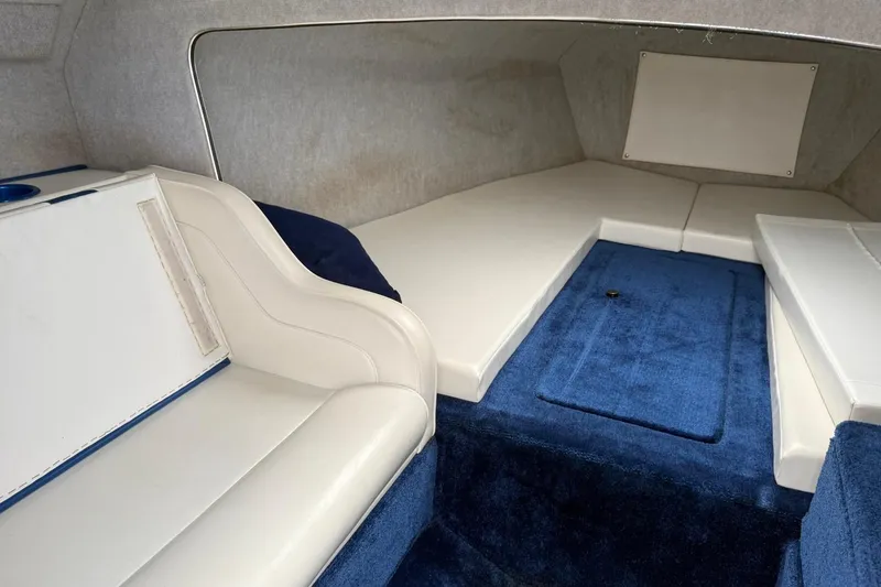 Slide: The Image of 2004 Eliminator 280 Eagle XP cabin interior with blue carpet and white seating. - 14