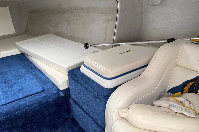 Slide: The Image of Interior of 2004 Eliminator 280 Eagle XP boat with blue carpet and white seating. - 15