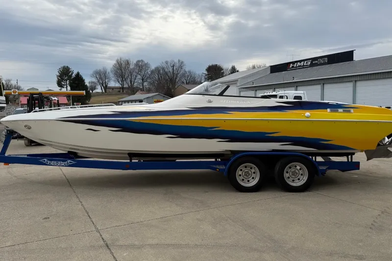 Slide: The Image of 2004 Eliminator 280 Eagle XP boat on trailer, vibrant yellow and blue design. - 5