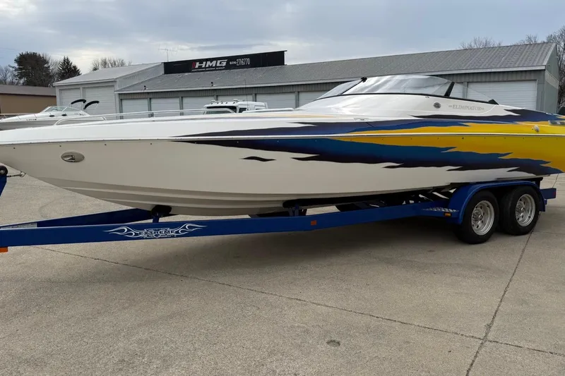 Slide: The Image of 2004 Eliminator 280 Eagle XP boat on blue trailer, vibrant yellow and blue design. - 7