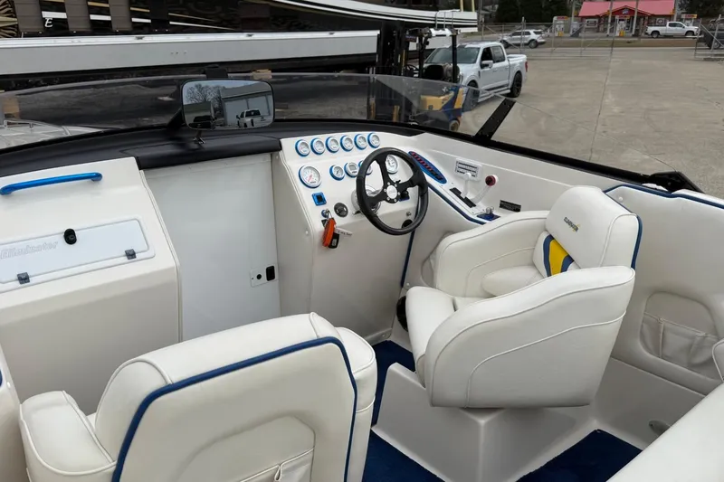 Slide: The Image of 2004 Eliminator 280 Eagle XP boat interior with white seating and dashboard controls. - 8