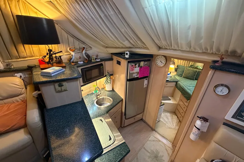 Slide: The Image of Interior of 2000 Carver 356 Aft Cabin Motor Yacht with kitchen and cozy bedroom. - 22