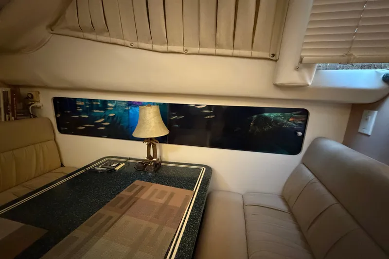 Slide: The Image of Interior of 2000 Carver 356 Aft Cabin Motor Yacht with cozy seating and lamp. - 25