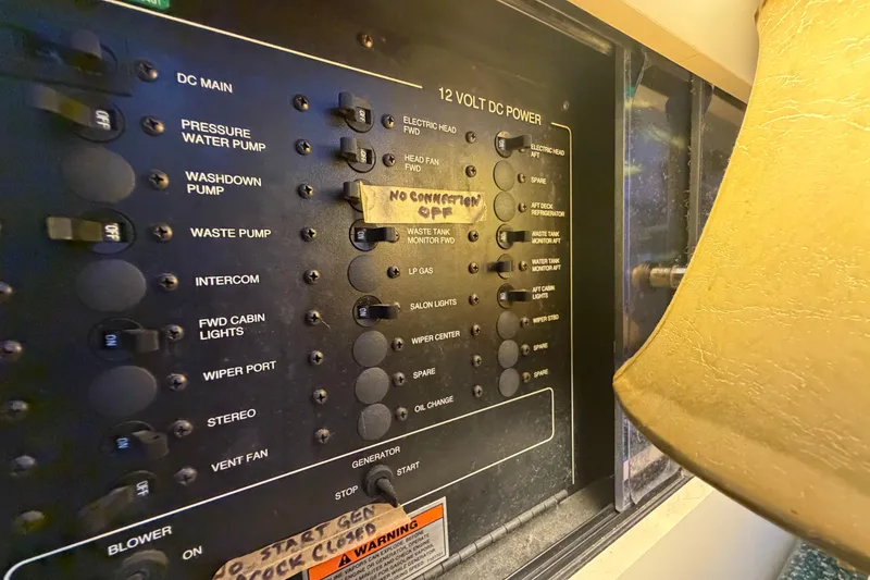 Slide: The Image of Control panel of a 2000 Carver 356 Aft Cabin Motor Yacht with labeled switches. - 28