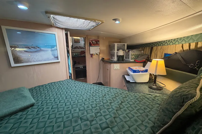 Slide: The Image of Cozy interior of 2000 Carver 356 Aft Cabin Motor Yacht with bed and lamp. - 31