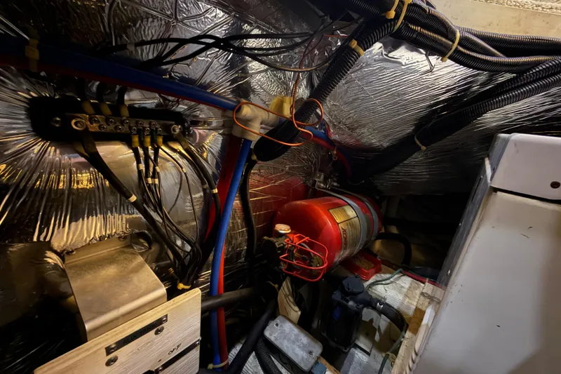 Slide: The Image of Engine room of 2000 Carver 356 Aft Cabin Motor Yacht with wiring and fire extinguisher. - 45