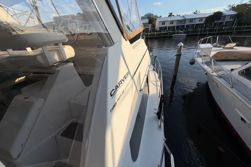 Slide: The Image of 2000 Carver 356 Aft Cabin Motor Yacht docked, showcasing sleek design and spacious interior. - 8