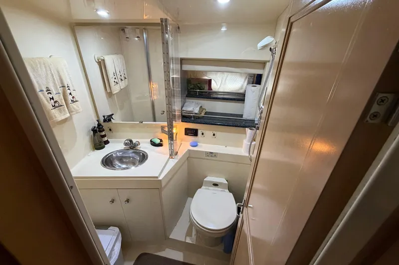 Slide: The Image of Bathroom interior of 2000 Carver 356 Aft Cabin Motor Yacht, featuring sink and toilet. - 24