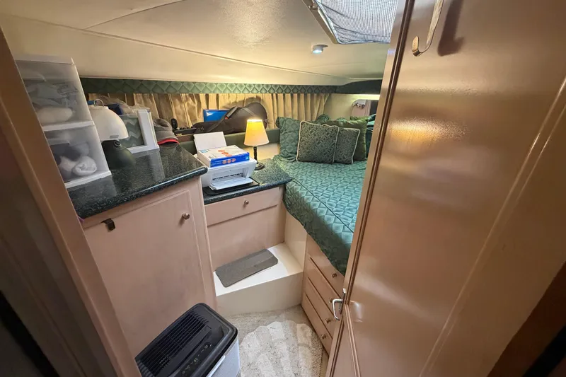 Slide: The Image of Interior of 2000 Carver 356 Aft Cabin Motor Yacht with cozy bed and storage. - 29
