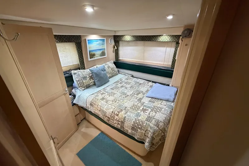 Slide: The Image of Interior of 2000 Carver 356 Aft Cabin Motor Yacht bedroom with cozy decor. - 32
