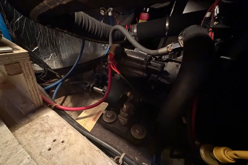 Slide: The Image of Engine compartment of 2000 Carver 356 Aft Cabin Motor Yacht with visible hoses and wiring. - 43