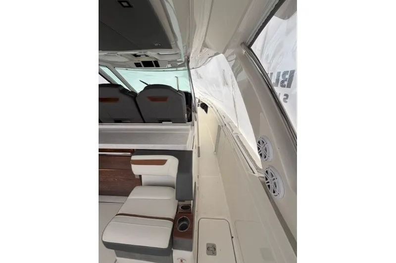 Slide: The Image of Interior view of 2021 Tiara Sport 38 LS boat, featuring seating and sleek design. - 12