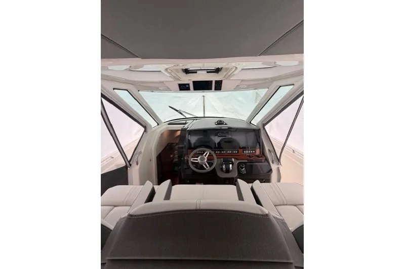 Slide: The Image of Interior view of 2021 Tiara Sport 38 LS boat cockpit with steering wheel and controls. - 13